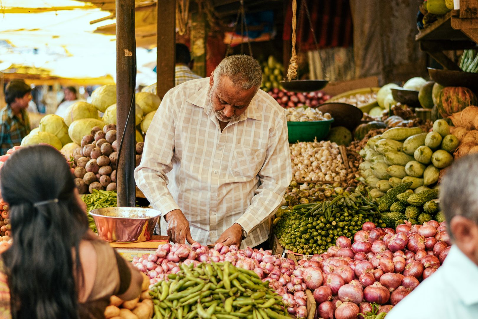 Local market stall with fresh produce and neighborhood shoppers