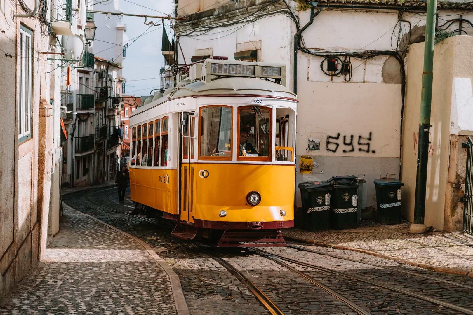 European city street with pedestrians and tram tracks